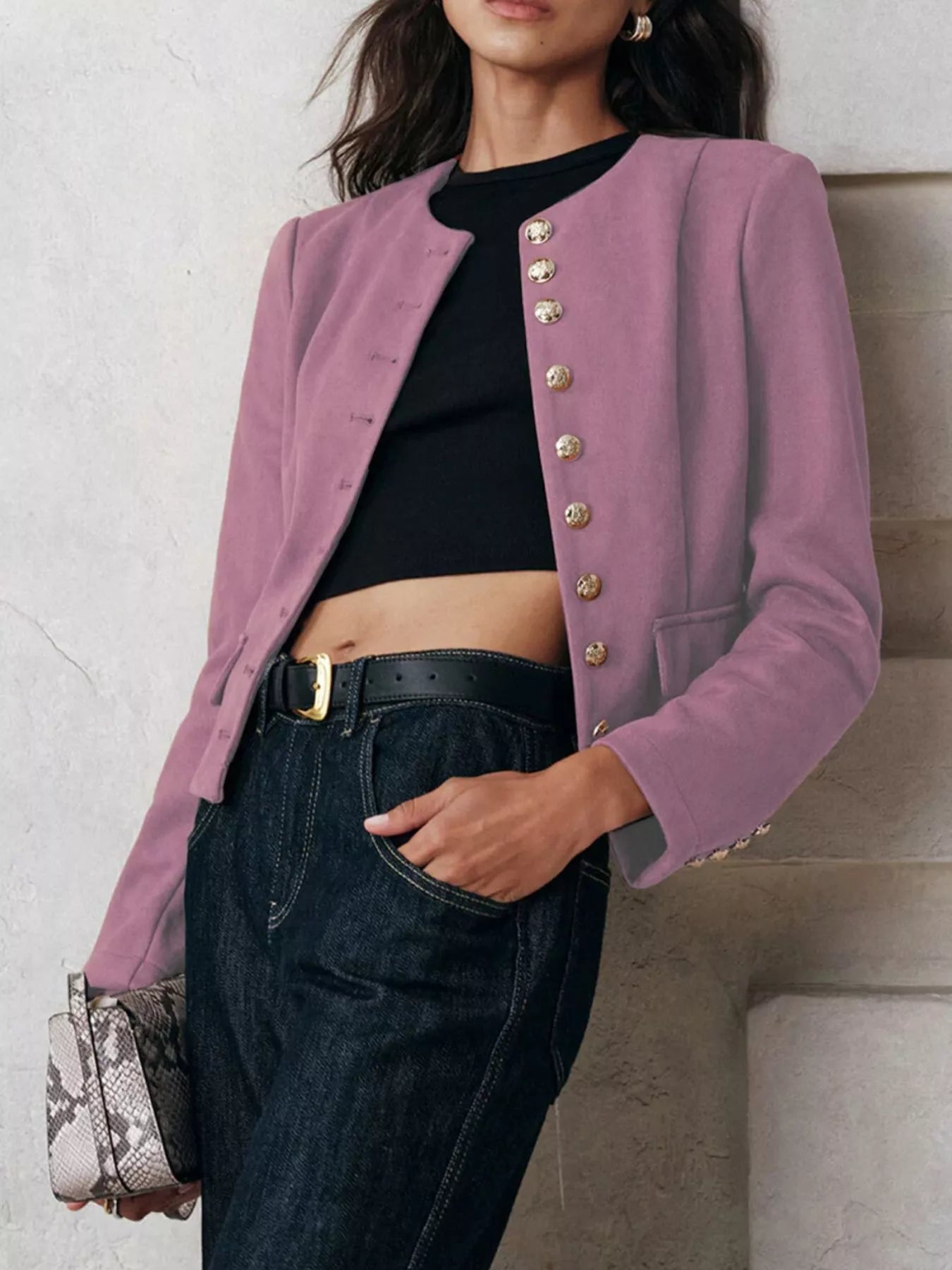 NEWYORKLISTED Style Collection Person wearing a pink blazer with gold buttons, black top, and jeans against a neutral background