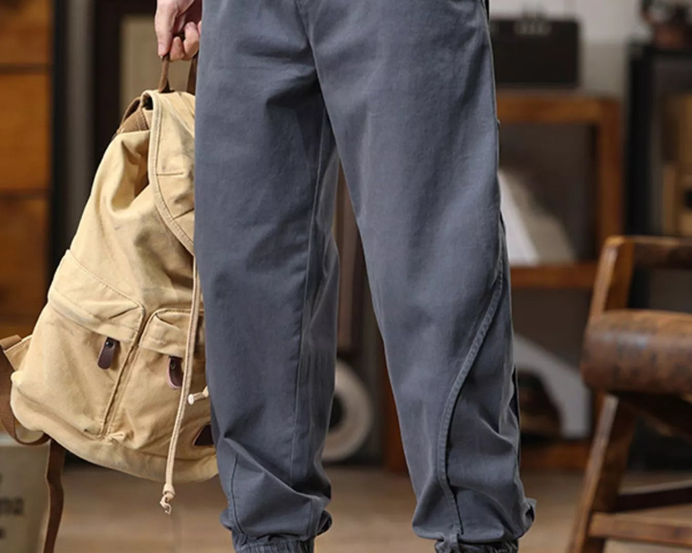 NEWYORKLISTED ATLAS MEN'S COLLECTION: Person wearing gray jogger pants and yellow boots in an indoor setting.