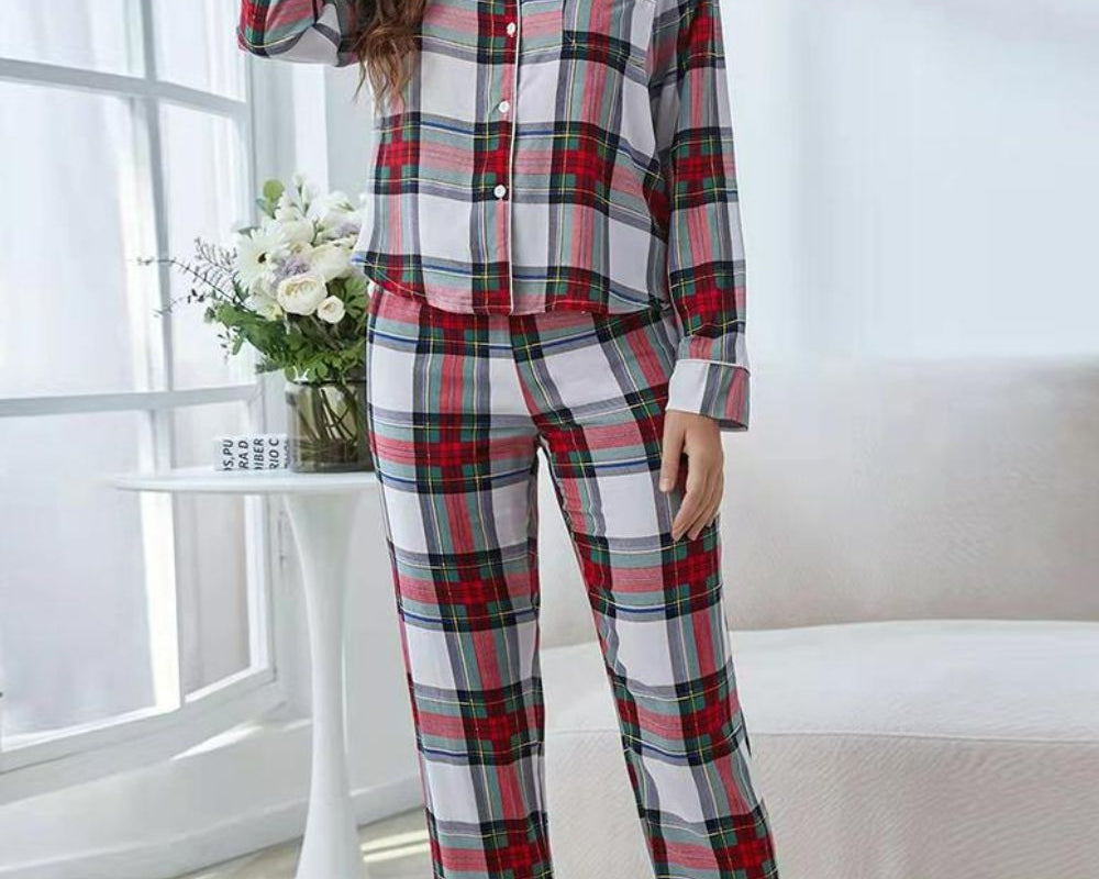 NEWYORKLISTED Intimate Apparel: Woman wearing a plaid pajama set in a bright room with white curtains and a white couch.