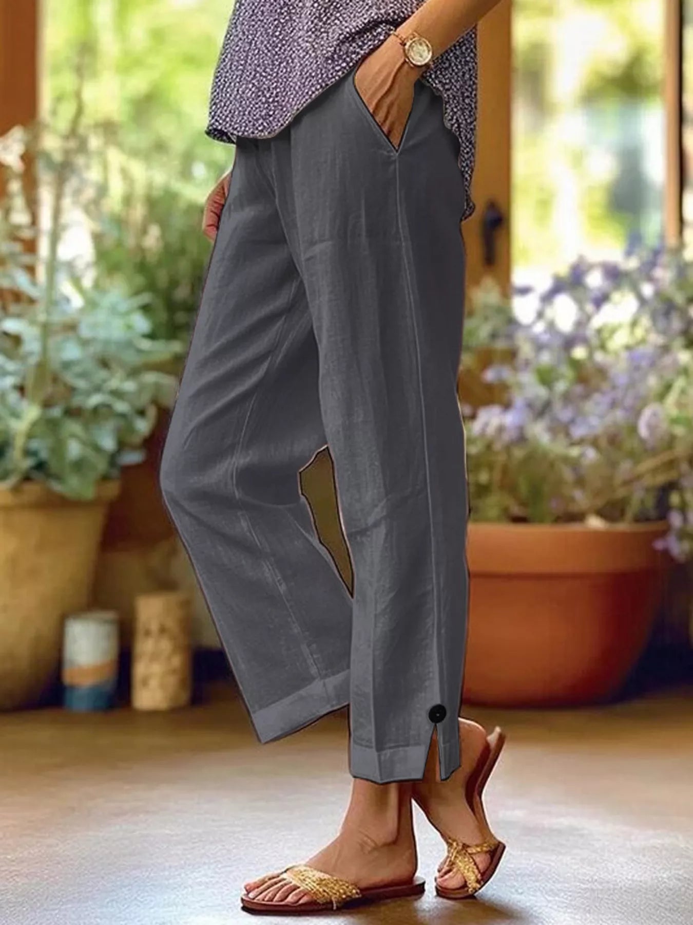 NEWYORKLISTED STYLE COLLECTION: Person wearing gray wide-leg pants with a blurred indoor background