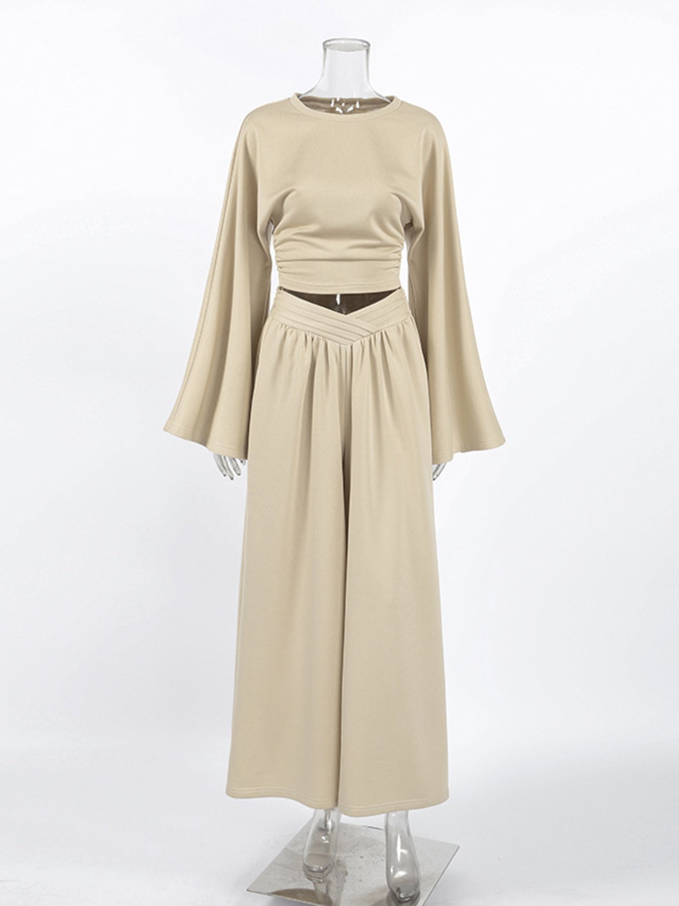 NEWYORKLISTED STYLE COLLECTION: Beige long-sleeve top and skirt set on a mannequin against a white background