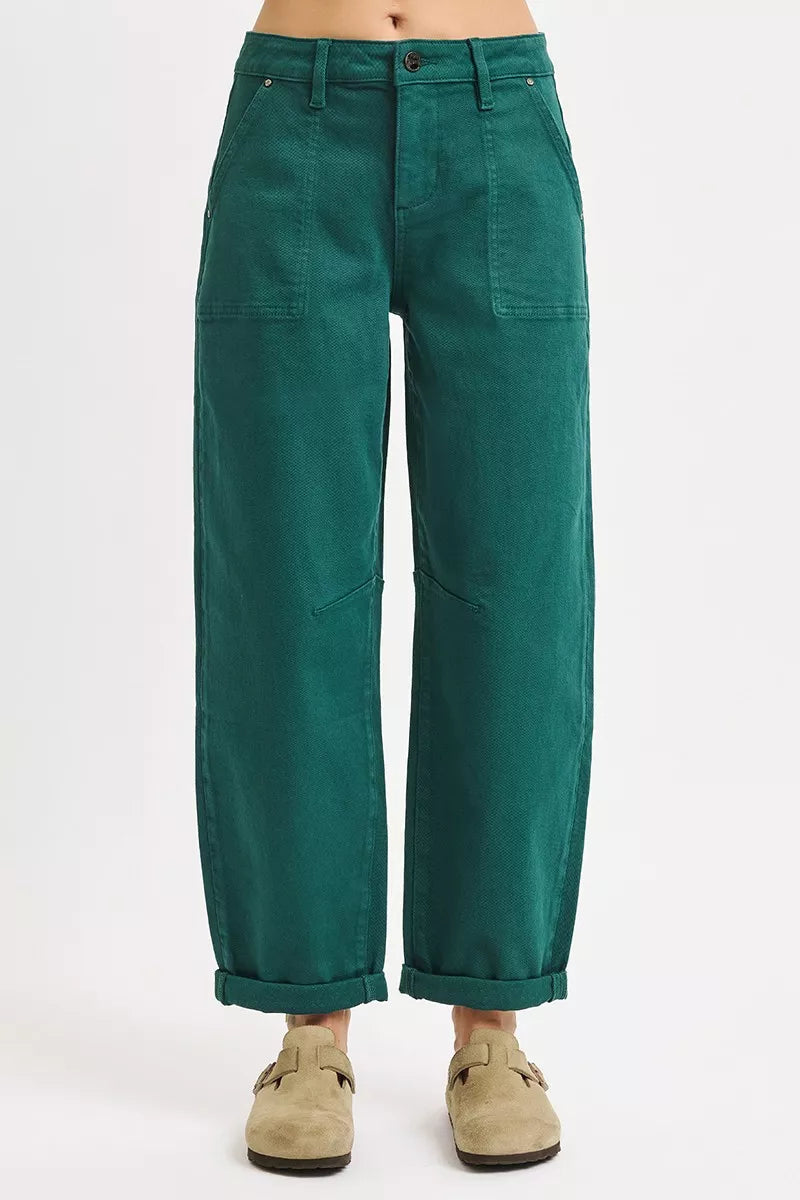 Green pants worn by a person on a white background: NEWYORKLISTED STYLE COLLECTION