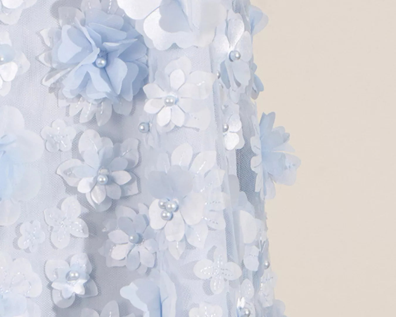 NEWYORKLISTED STYLE COLLECTION: Close-up of a decorative floral garland with light blue and white flowers on a neutral background