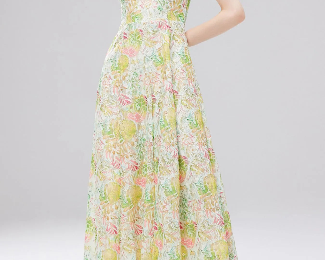 NEWYORKLISTED STYLE COLLECTION: Woman wearing a floral dress on a gray background
