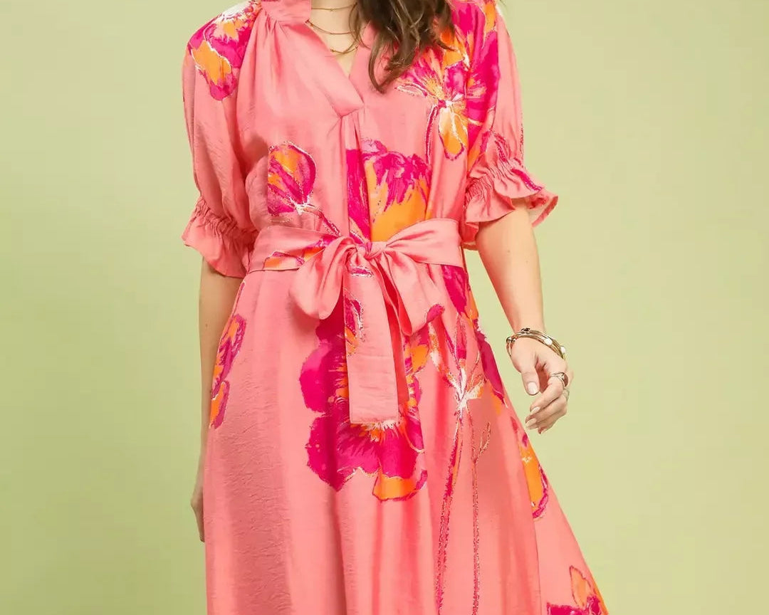 NEWYORKLISTED STYLE COLLECTION: Woman wearing a pink floral dress on a light green background