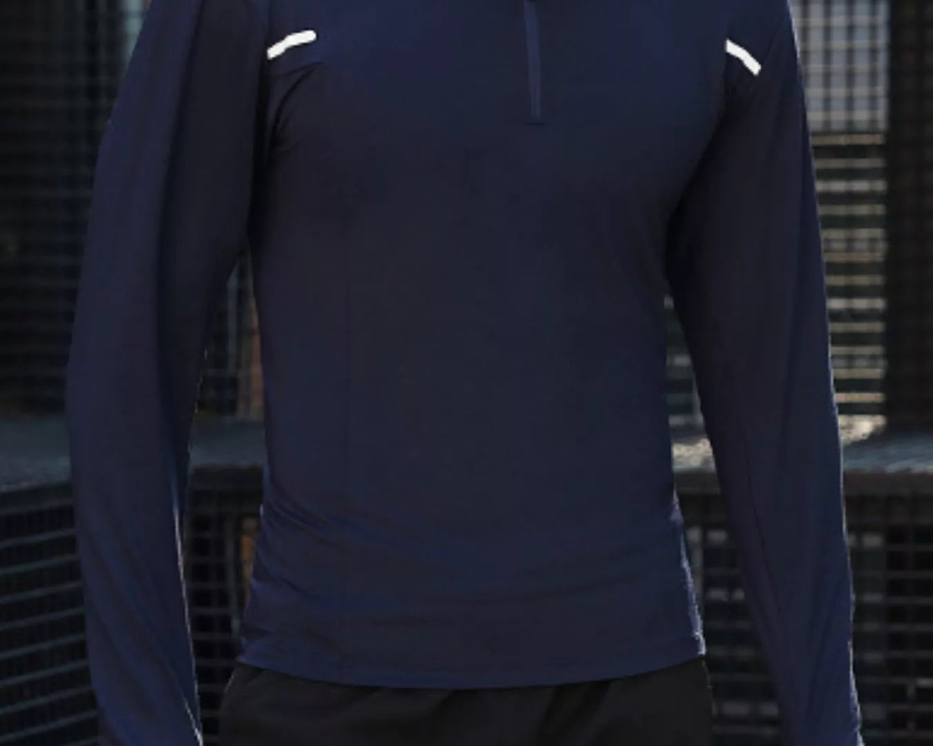 NEWYORKLISTED ATLAS MEN'S COLLECTION: Person wearing a navy long-sleeve athletic shirt with white accents against a dark background