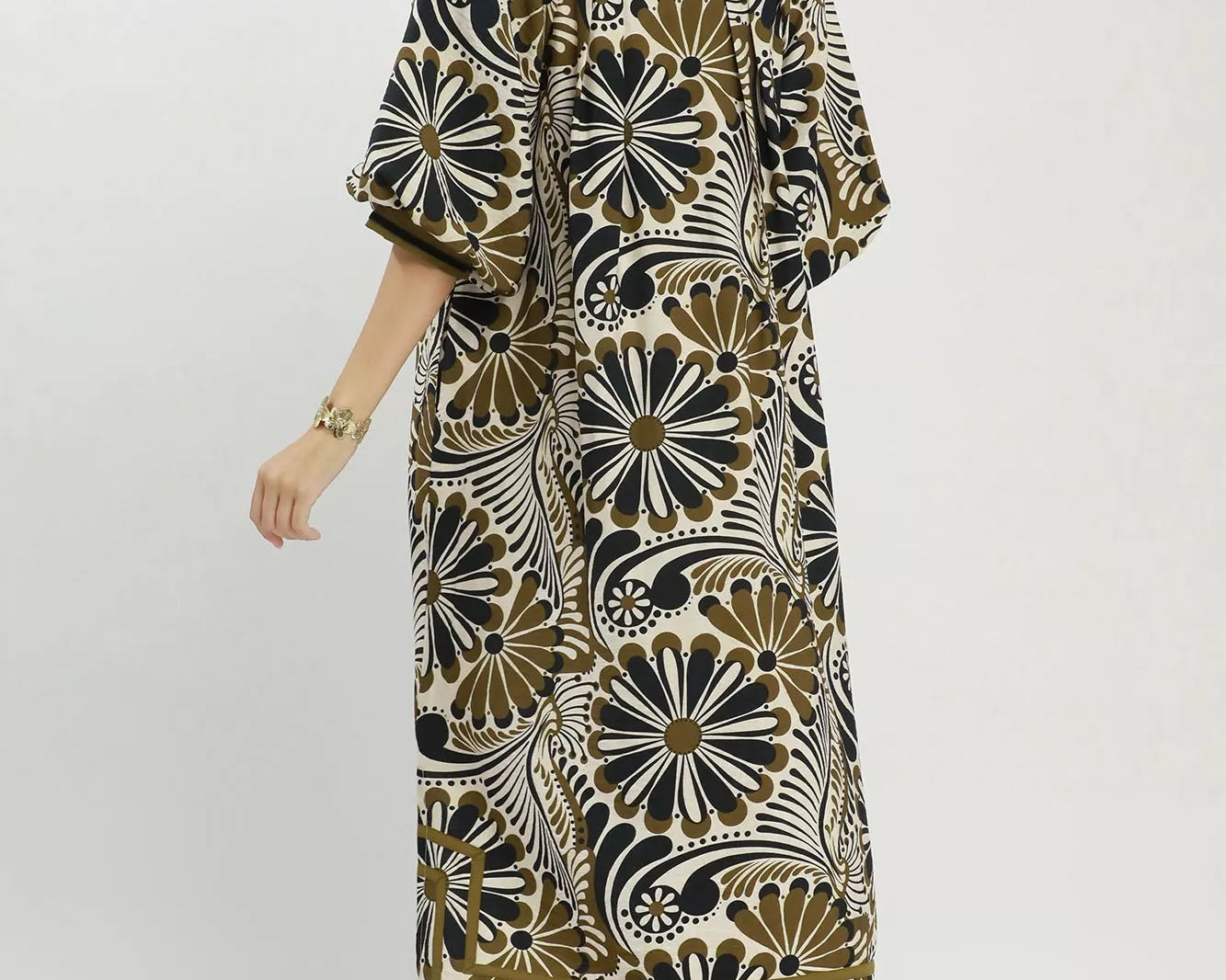 NEWYORKLISTED STYLE COLLECTION: Woman wearing a patterned dress on a white background