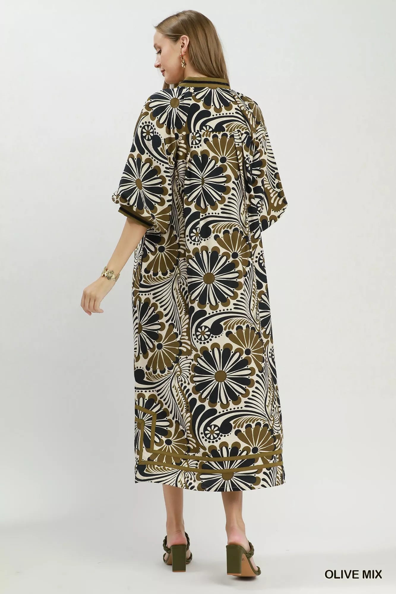 NEWYORKLISTED STYLE COLLECTION: Woman wearing a patterned dress on a white background