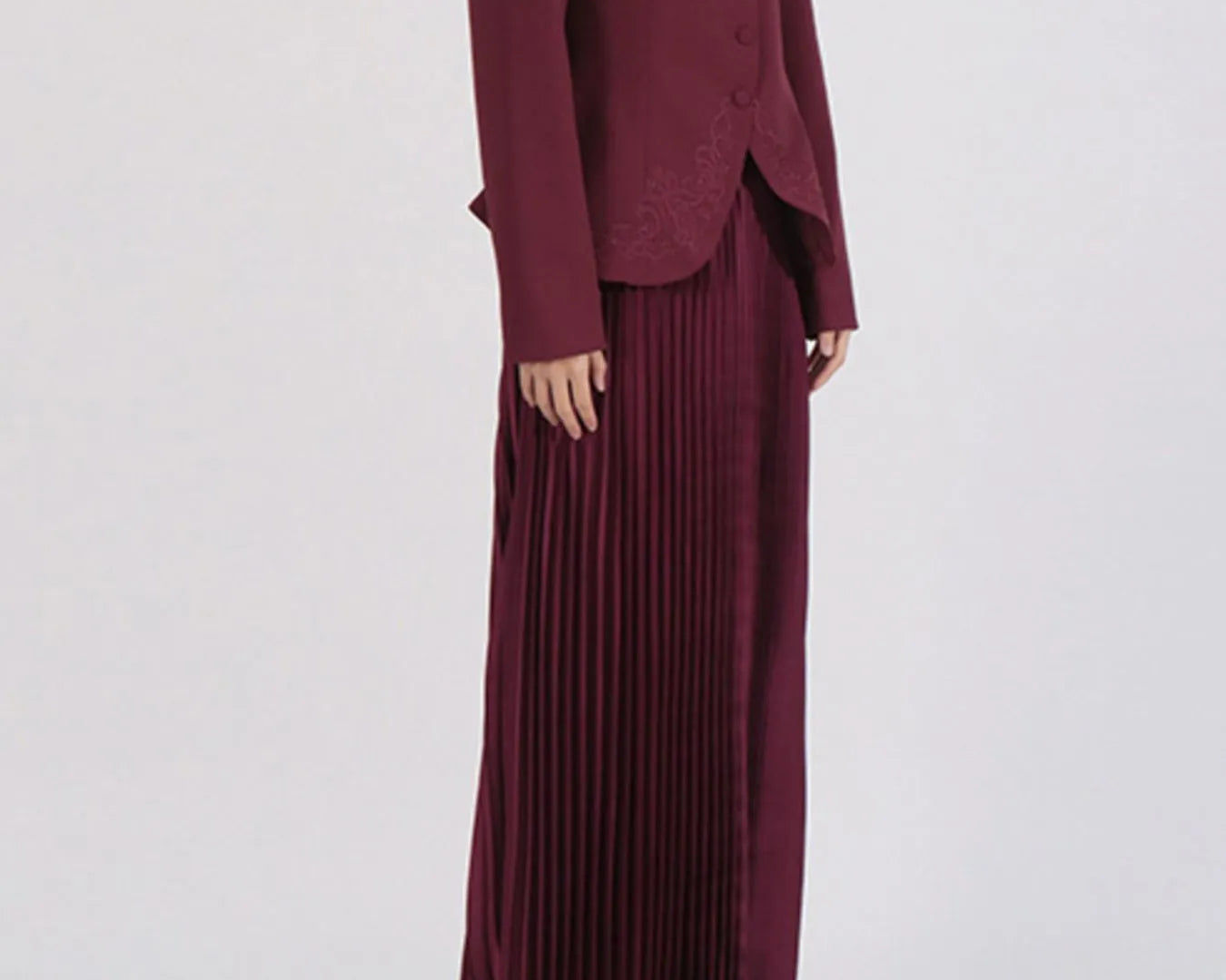NEWYORKLISTED STYLE COLLECTION: Maroon suit with a long pleated skirt on a white background