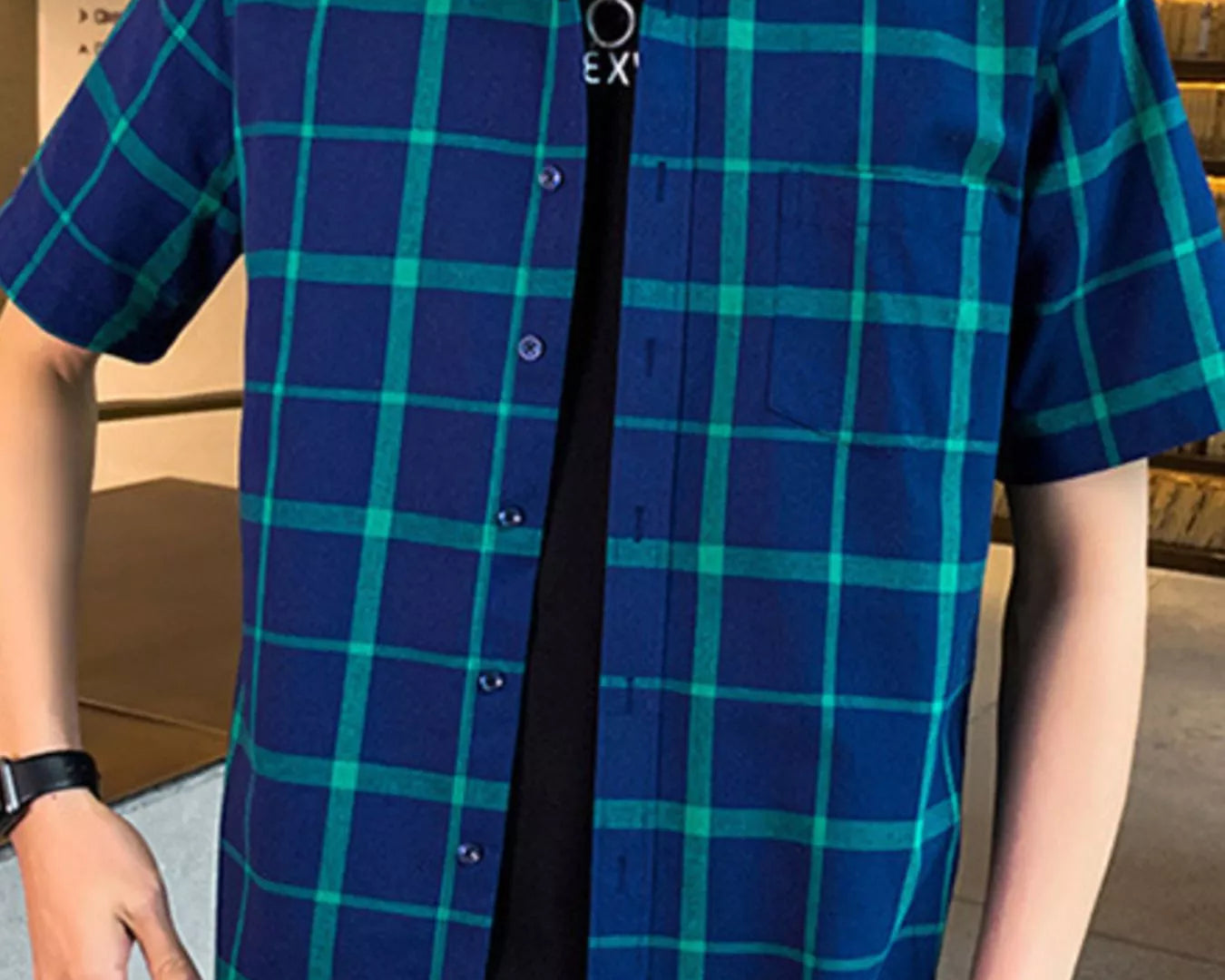 NEWYORKLISTED ATLAS MEN'S COLLECTION: Person wearing a blue and green checkered shirt indoors.