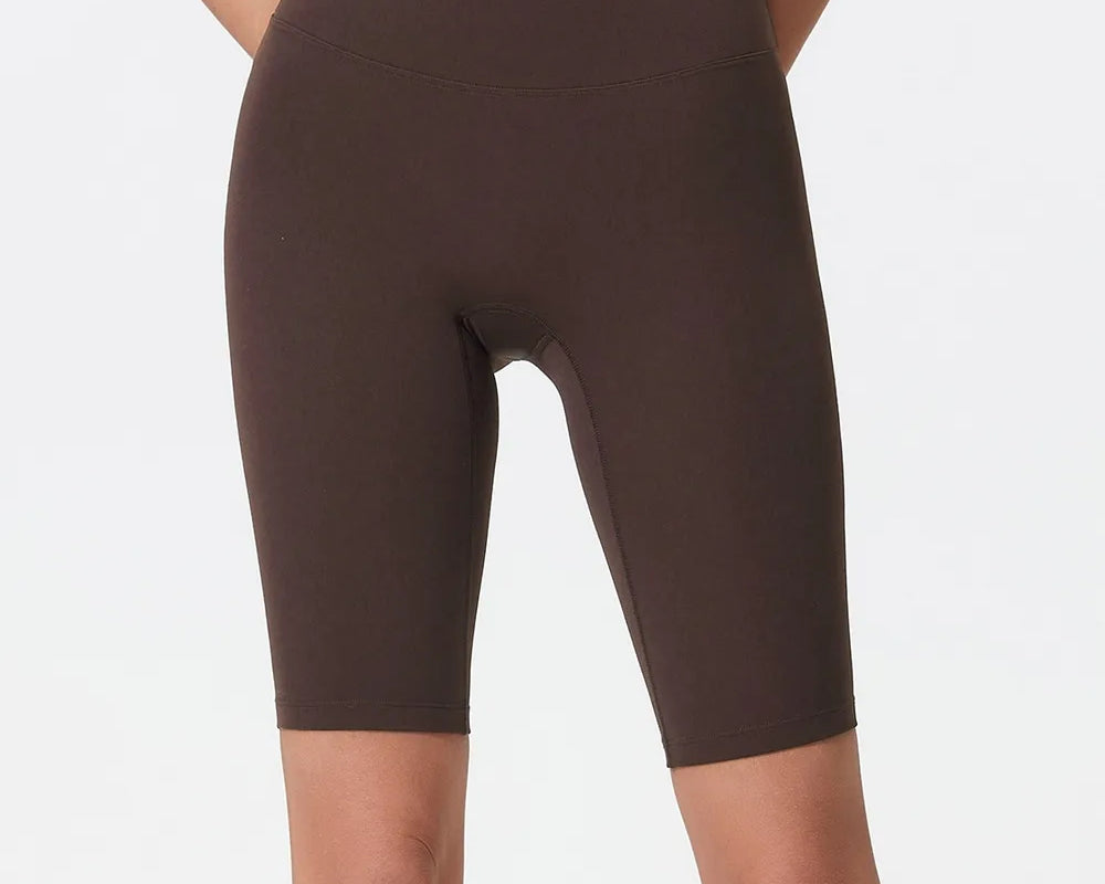 NEWYORKLISTED ACTIVEWEAR COLLECTION: Brown high-waisted shorts worn by a person on a white background