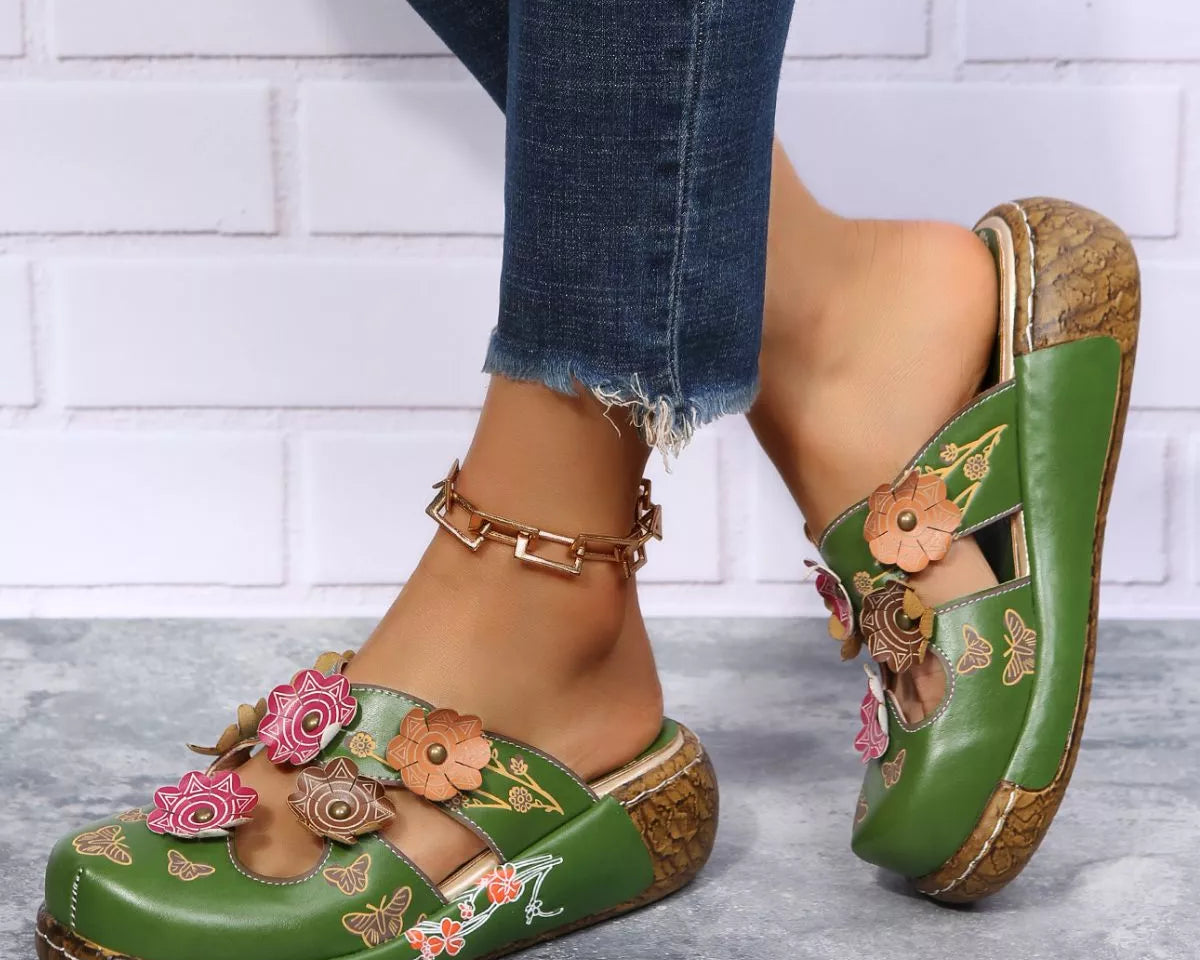 NEWYORKLISTED SHOE COLLECTION: Green floral sandals worn with denim jeans on a light background