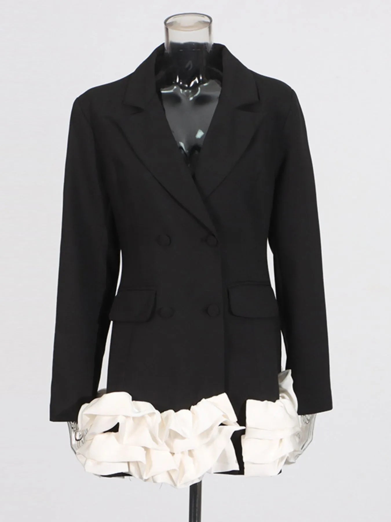 NEWYORKLISTED Runway Style: Black blazer on a mannequin with white floral skirt against a gray background