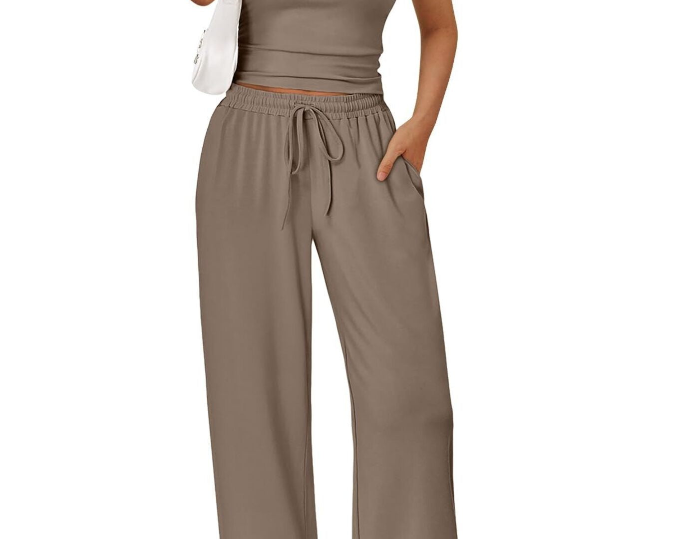 NEWYORKLISTED COMFORT COLLECTION: Woman wearing a beige crop top and wide-leg pants on a white background