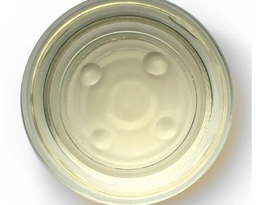 Close-up of NEWYORKLISTED castor oil jar lid with a white background