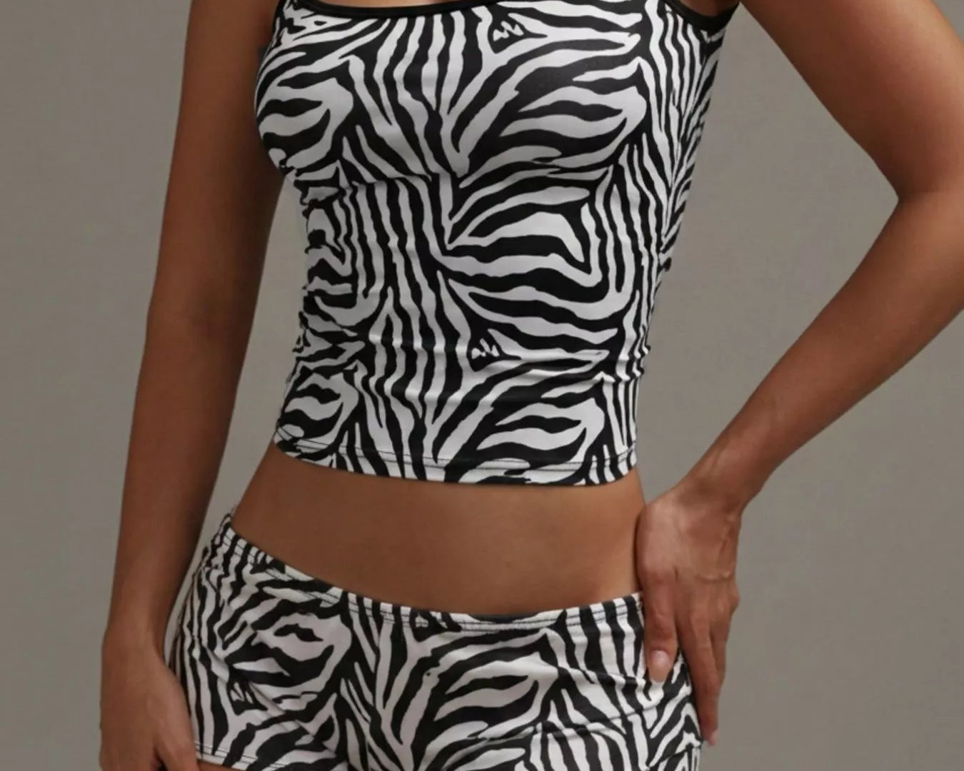 NEWYORKLISTED INTIMATE APPAREL COLLECTION: Person wearing a zebra print tank top and shorts set against a neutral background