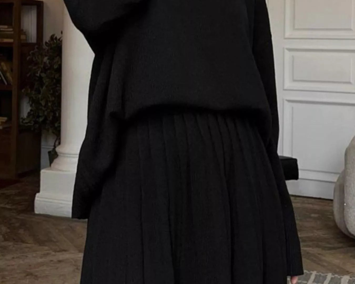 Person wearing a black outfit in an indoor setting on NEWYORKLISTED.COM