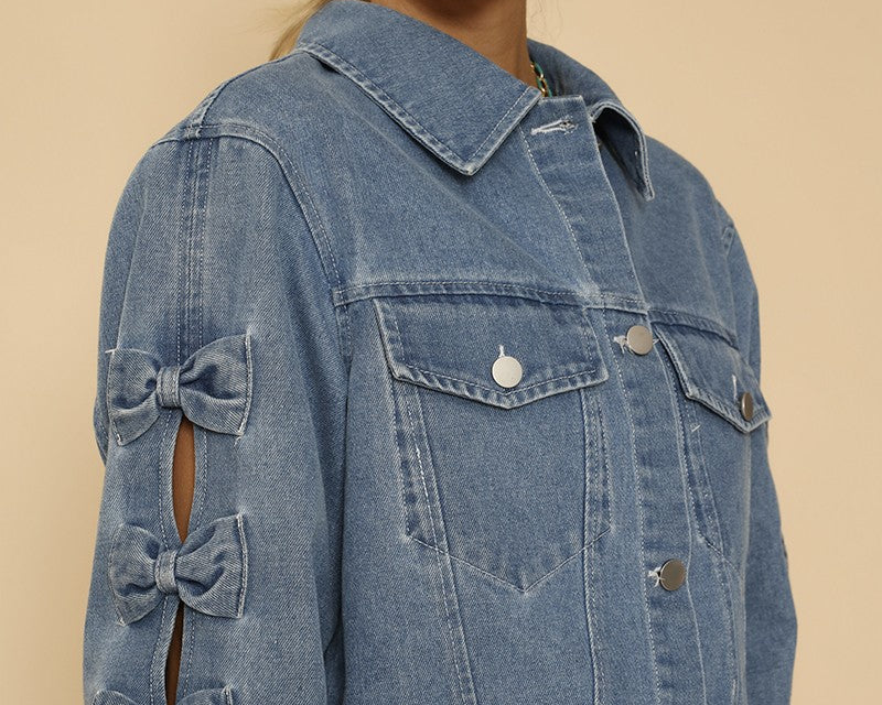 NEWYORKLISTED STYLE COLLECTION: Denim jacket with bow details on a beige background