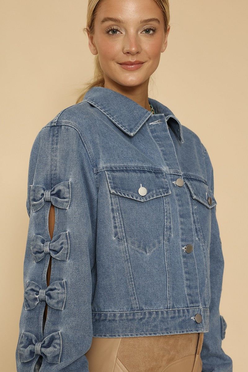 NEWYORKLISTED STYLE COLLECTION: Denim jacket with bow details on a beige background