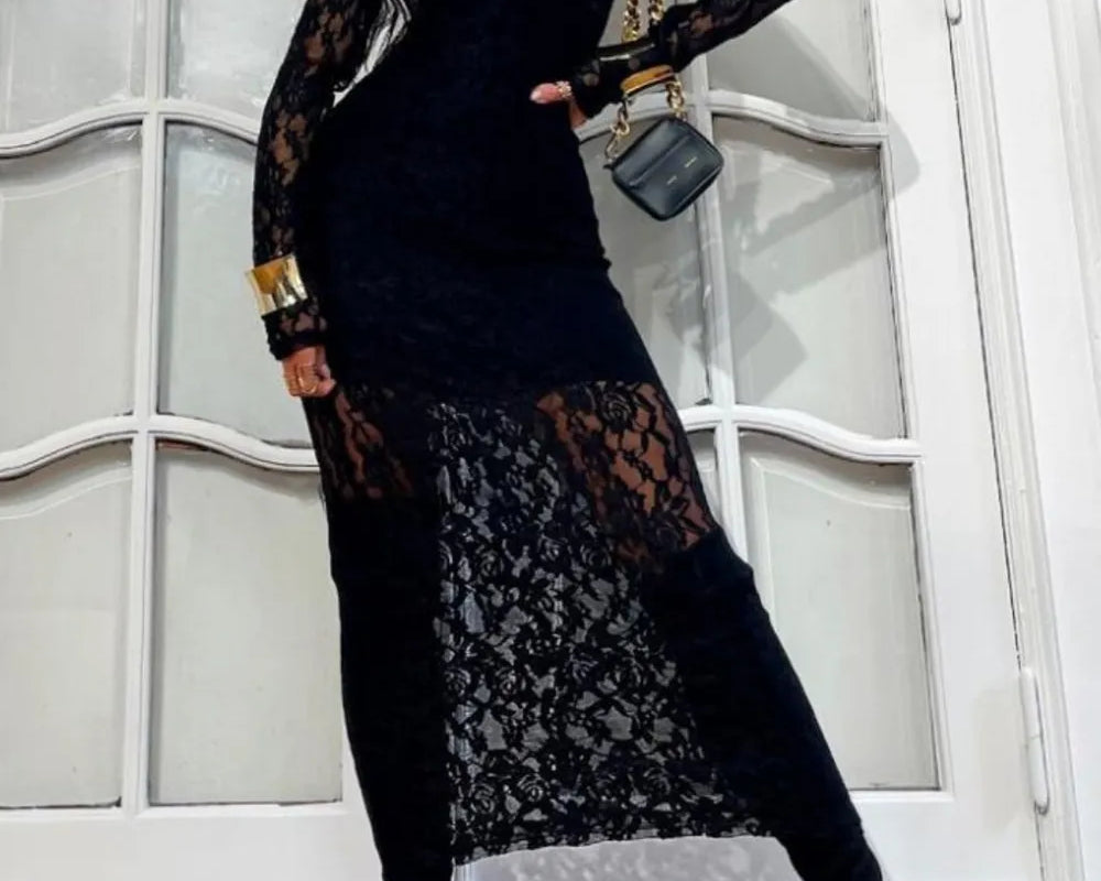 NEWYORKLISTED Valentine's Day Specials: Fashion model wearing a black lace dress with long sleeves and a matching bag against a white wall.