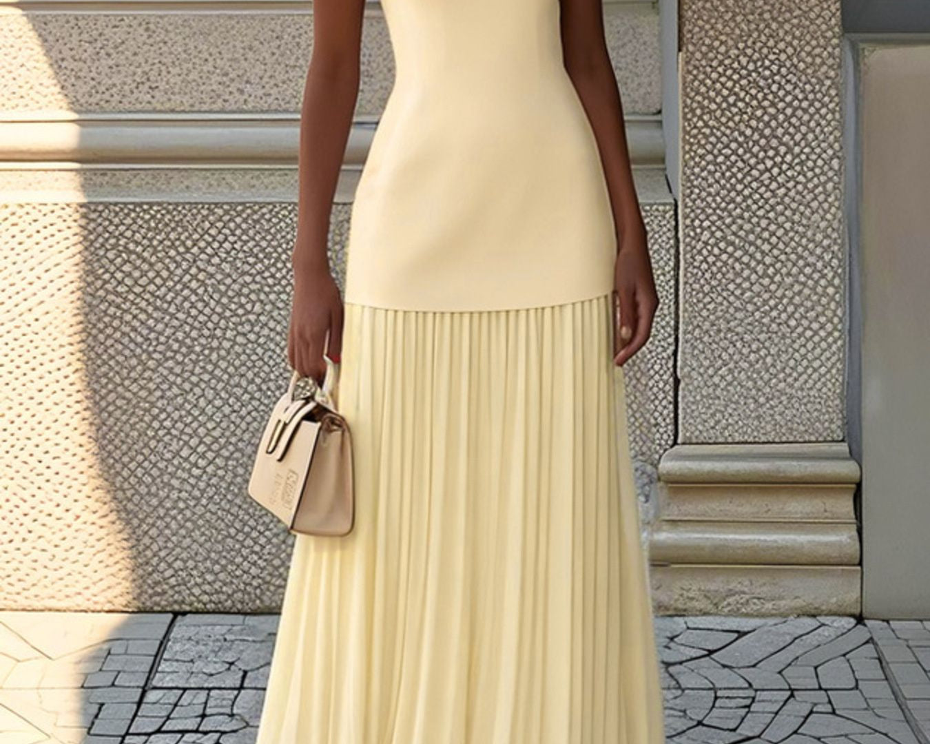 NEWYORKLISTED STYLE COLLECTION: Woman in a long beige dress standing on a stone pavement.