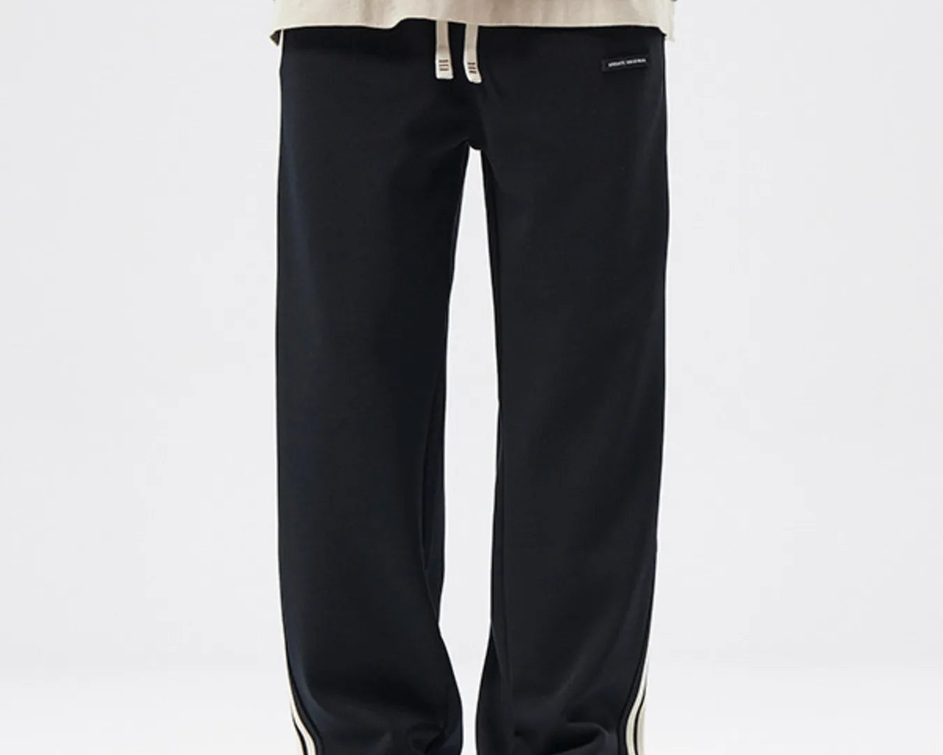 NEWYORKLISTED ATLAS MEN's COLLECTION: Person wearing black pants with a white background
