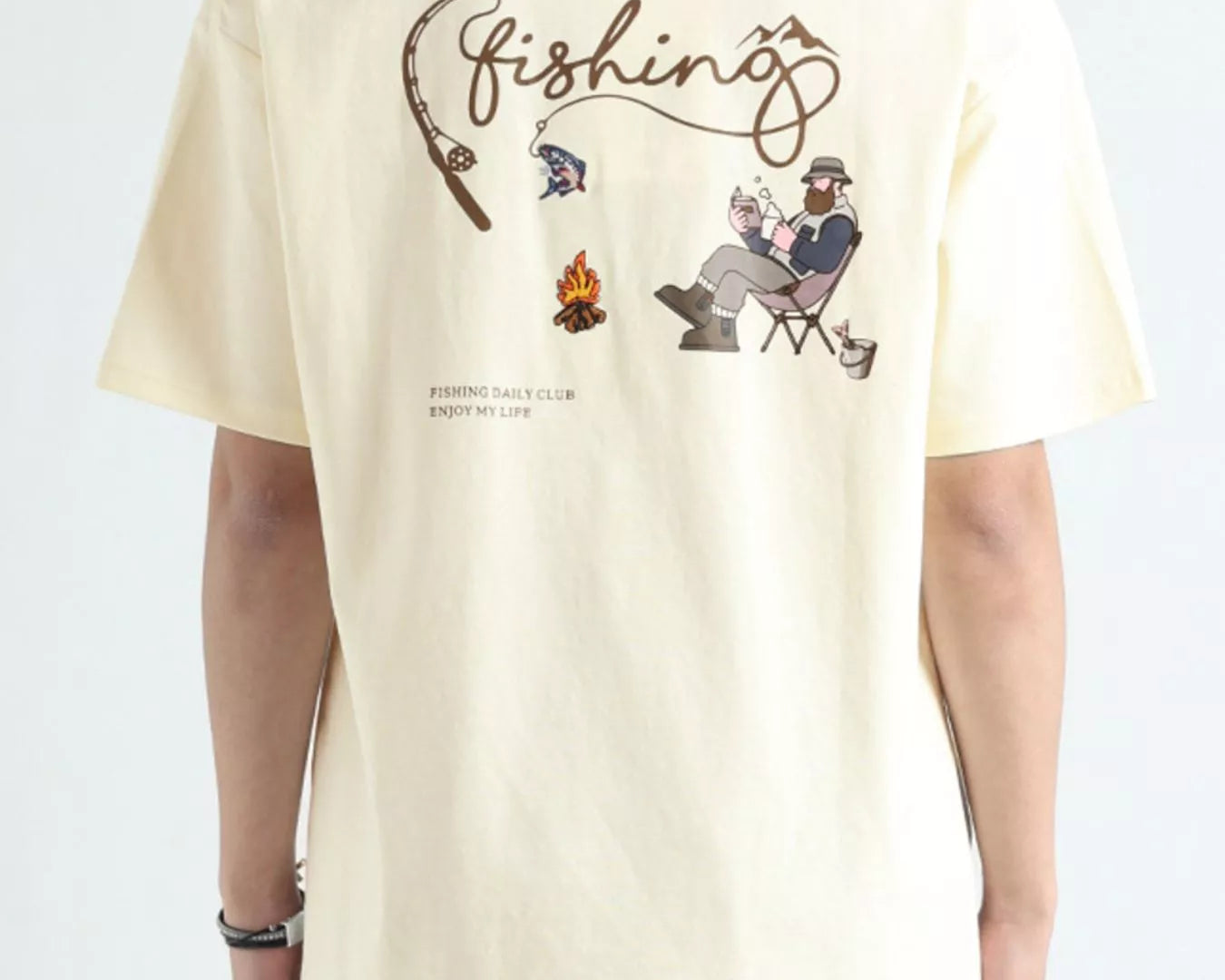 Beige t-shirt with fishing-themed graphics and text on a white background