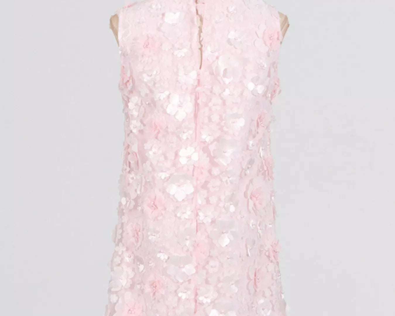 NEWYORKLISTED STYLE COLLECTION: Pink sleeveless dress on a mannequin against a gray background