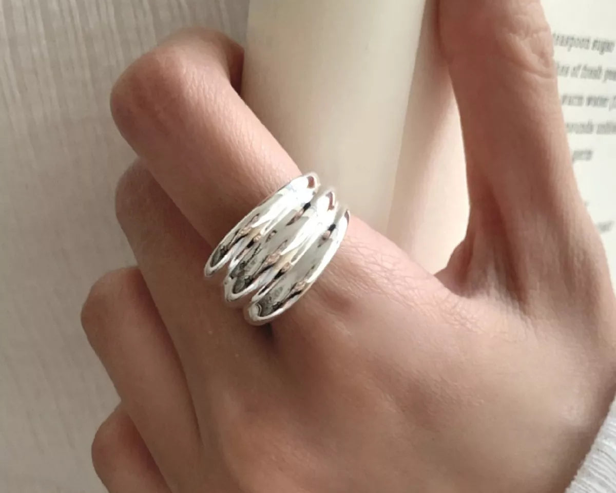 NYLD Glamour Collection: Silver ring on a finger with a blurred background