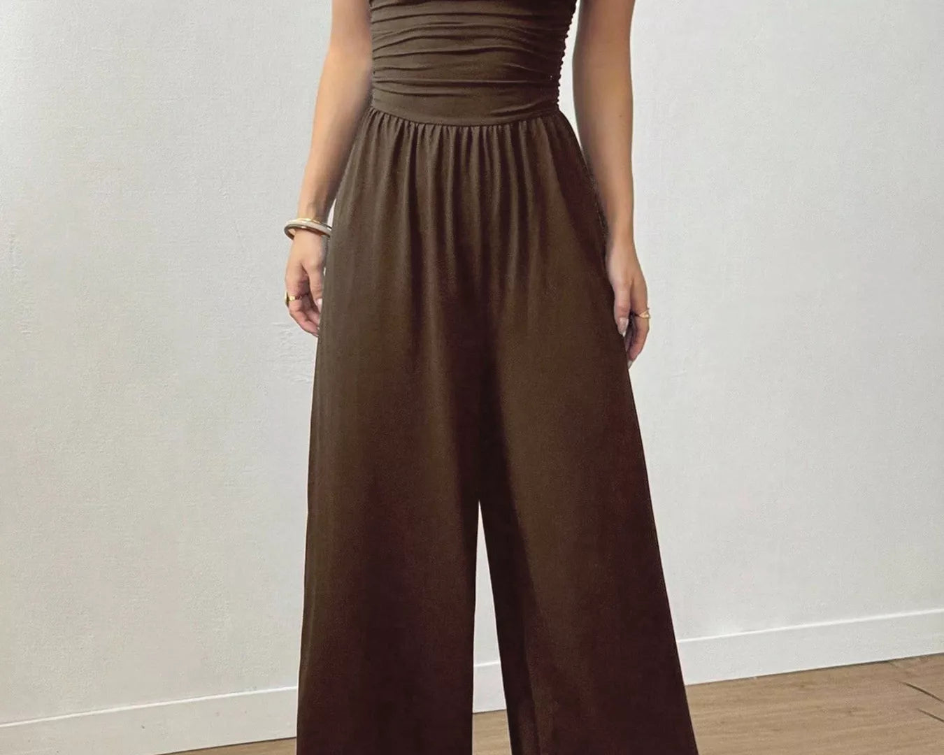 NEWYORKLISTED Comfort Collection: Woman wearing a burgundy jumpsuit on a plain background