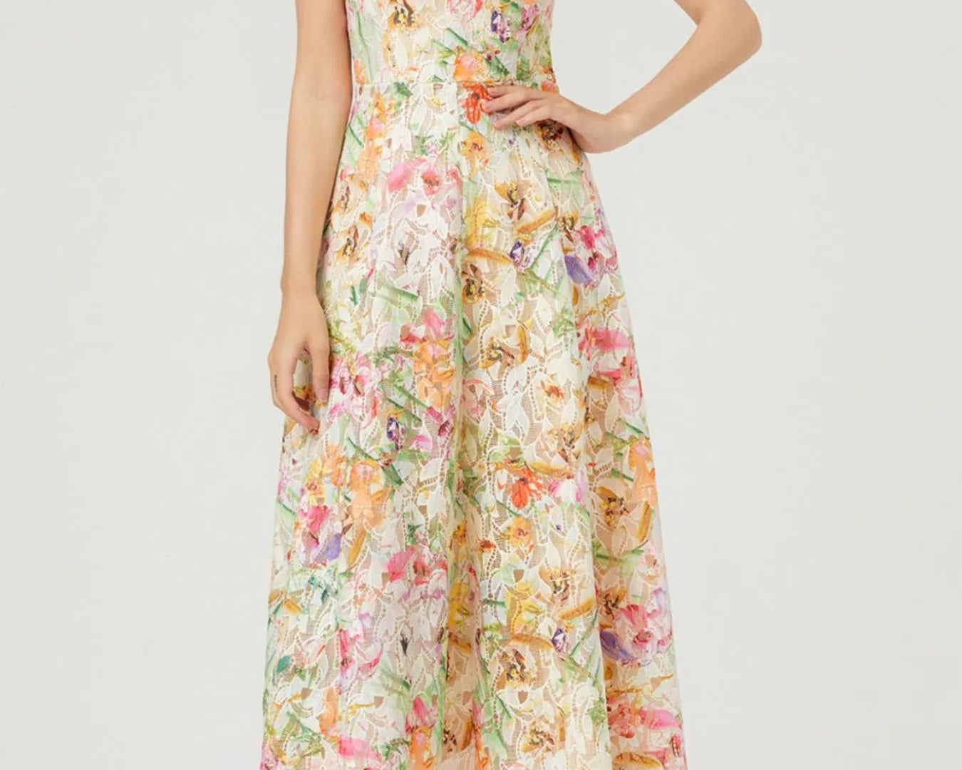 NEWYORKLISTED STYLE COLLECTION: Woman wearing a floral dress on a white background