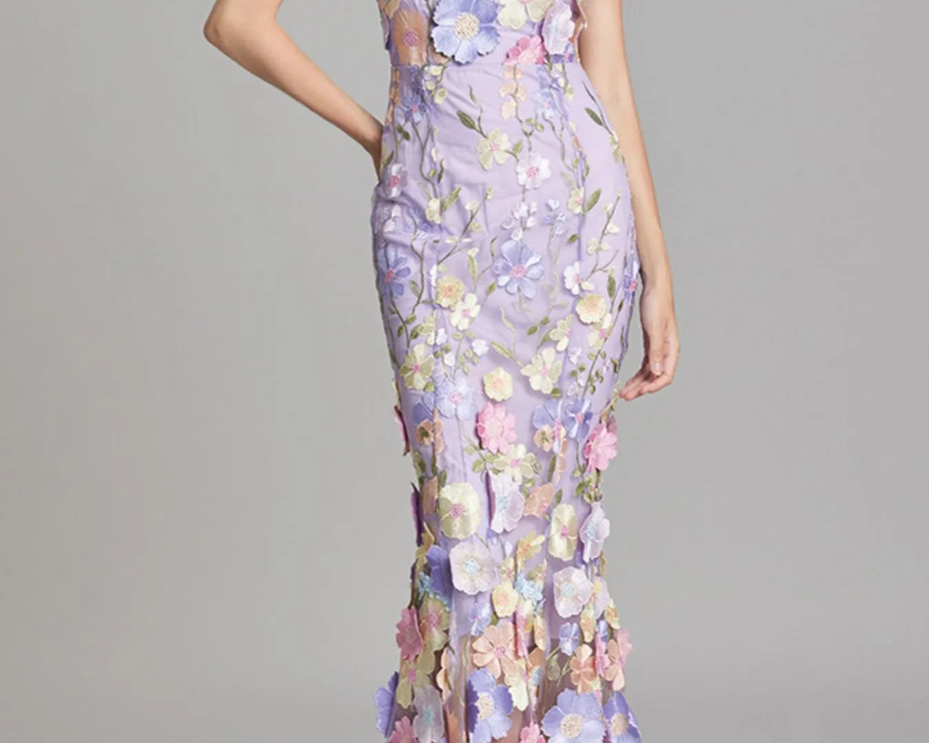 NEWYORKLISTED STYLE COLLECTION: Woman wearing a floral dress with a gray background