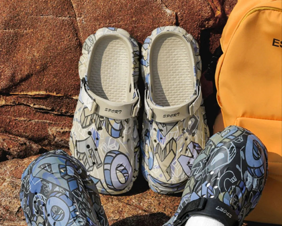 NEWYORKLISTED ATLAS MEN'S COLLECTION: Pair of patterned sandals and matching leggings on a rocky surface