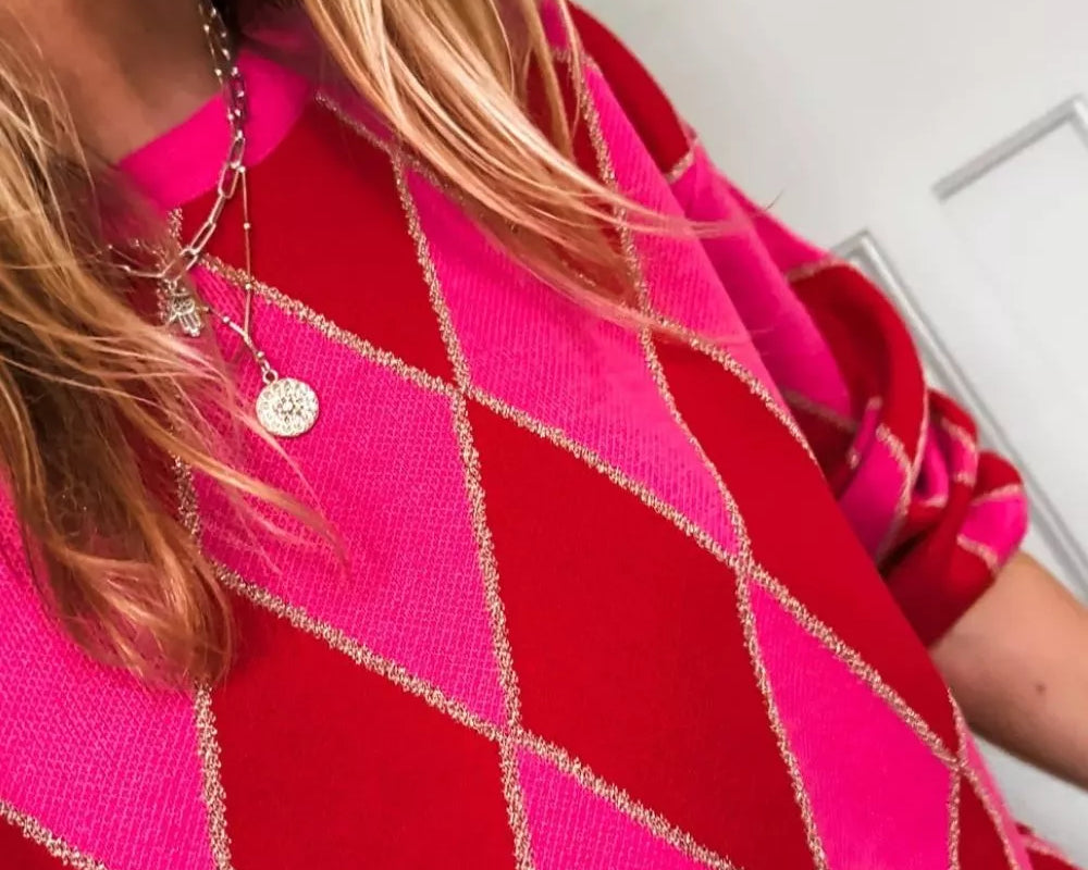 NEWYORKLISTED STYLE COLLECTION: Person wearing a bright pink and red patterned garment with a blurred background