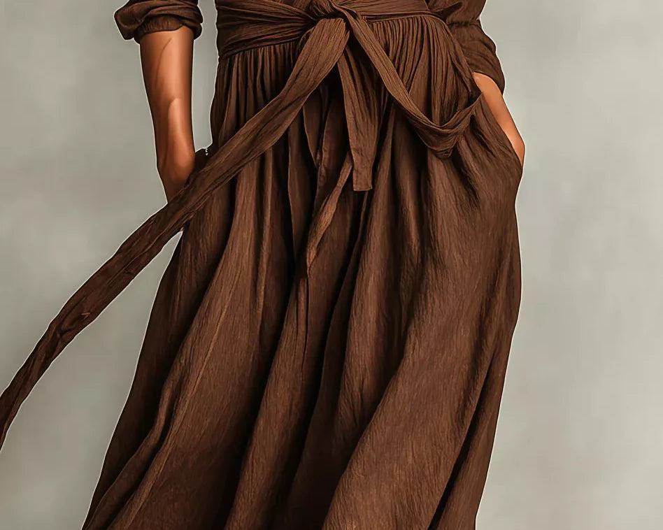 NEWYORKLISTED STYLE COLLECTION: Brown dress with a tie waist on a neutral background