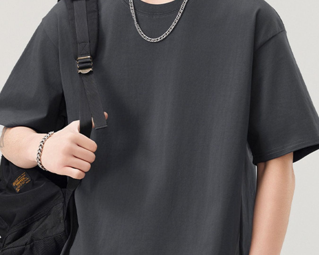 NEWYORKLISTED ATLAS MEN"S COLLECTION: Person wearing a black t-shirt with a plain background
