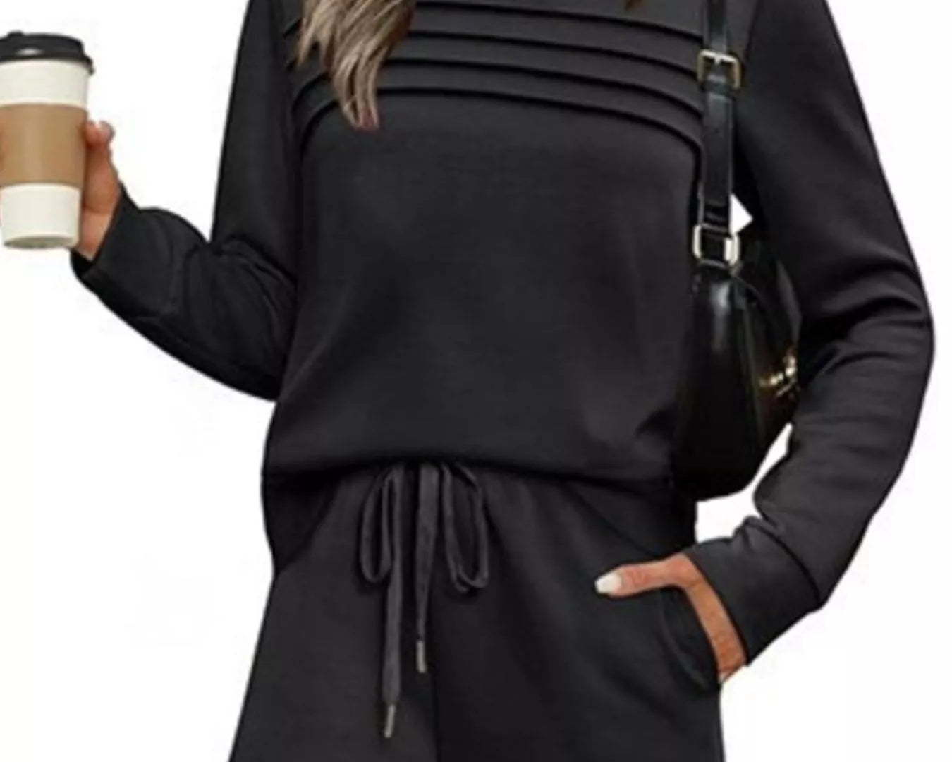 NEWYORKLISTED COMFORT COLLECTION: Woman wearing a black outfit holding a coffee cup on a white background