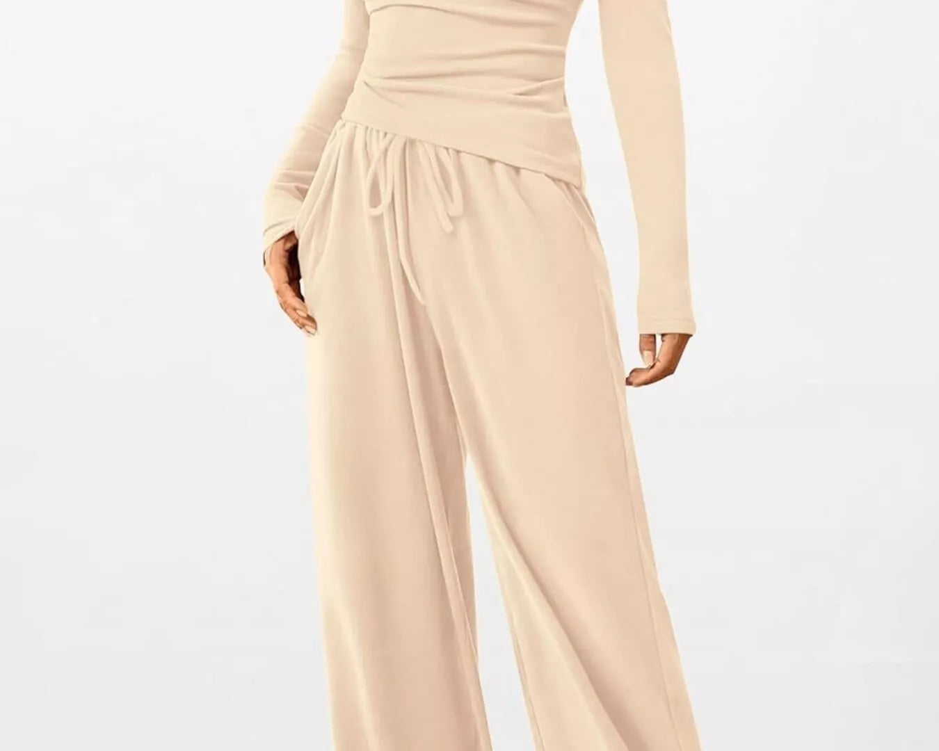 Beige jumpsuit with long sleeves on a white background