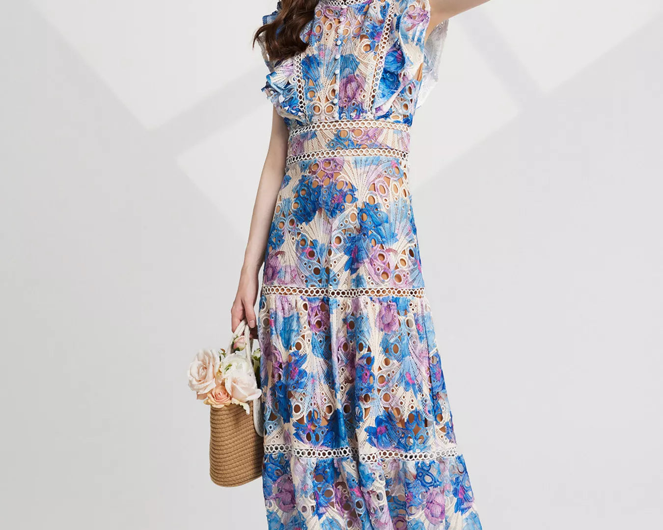 NEWYORKLISTED STYLE COLLECTION: Woman wearing a floral dress on a white background