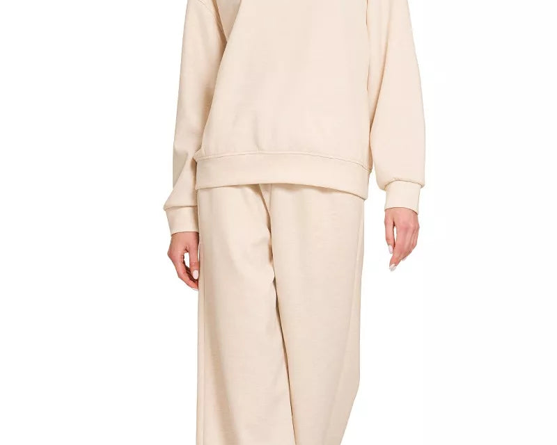 NEWYORKLISTED STYLE COLLECTION: Woman wearing a beige outfit on a white background