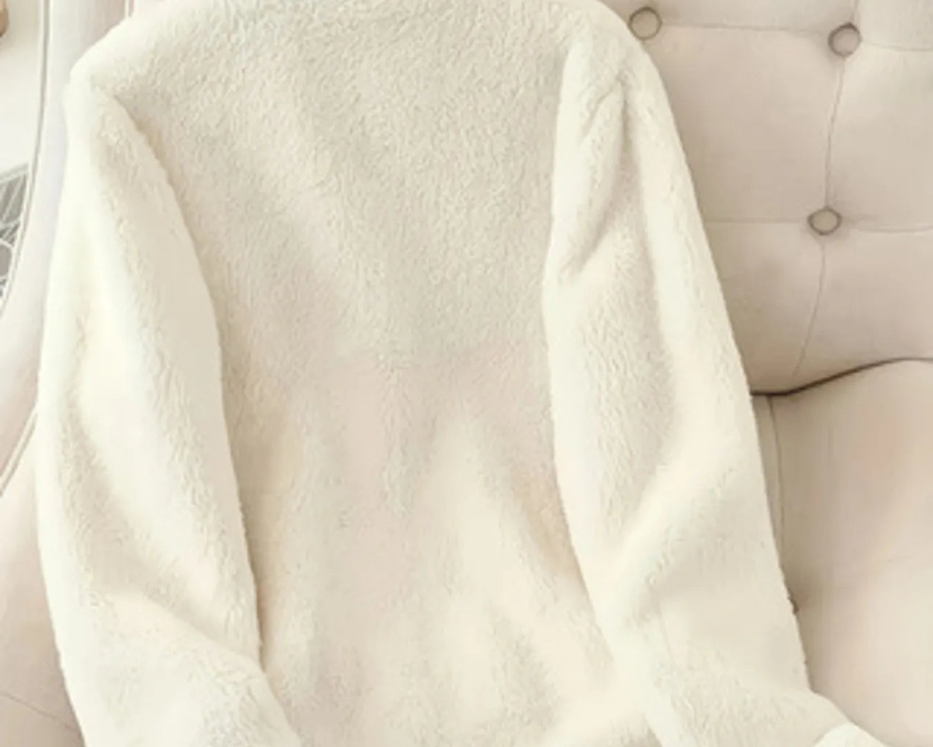 NEWYORKLISTED fleece zip-up jacket – women’s casual fashion on a beige upholstered chair