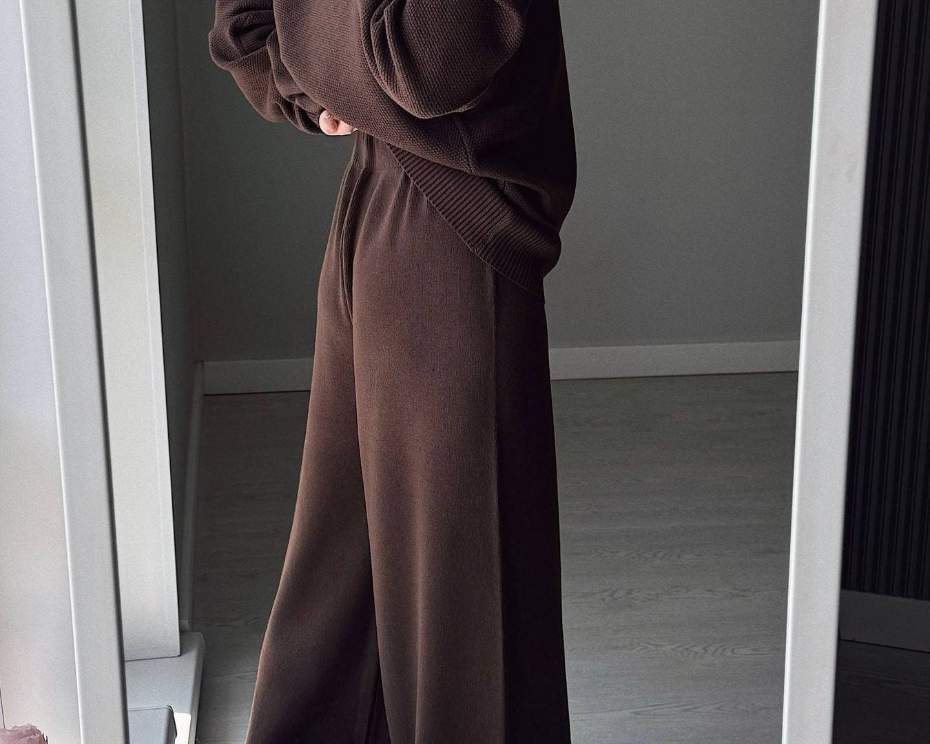 NEWYORKLISTED Comfort Collection: Person wearing a brown outfit standing in front of a mirror.
