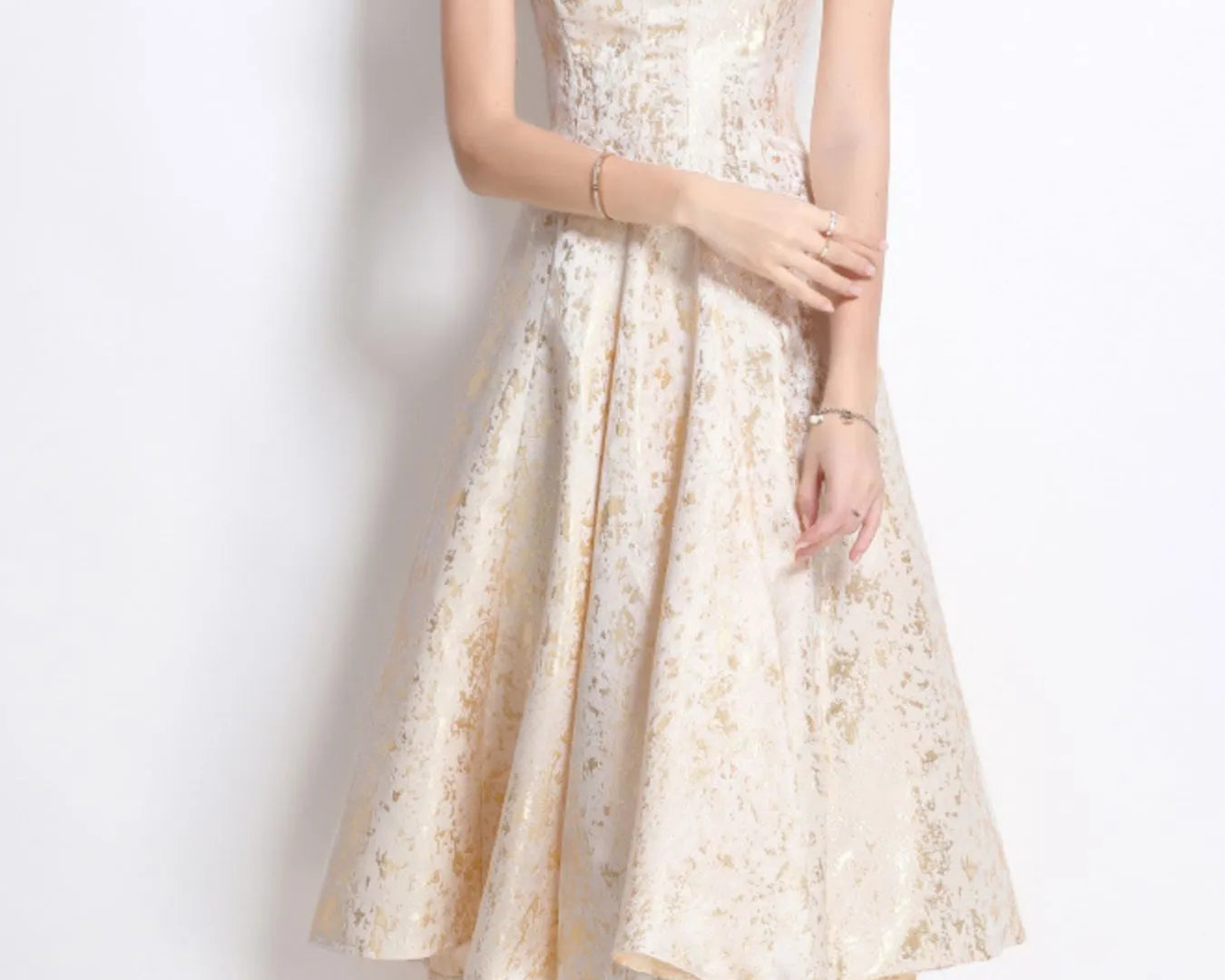 NEWYORKLISTED STYLE COLLECTION: Woman wearing a floral dress against a white background