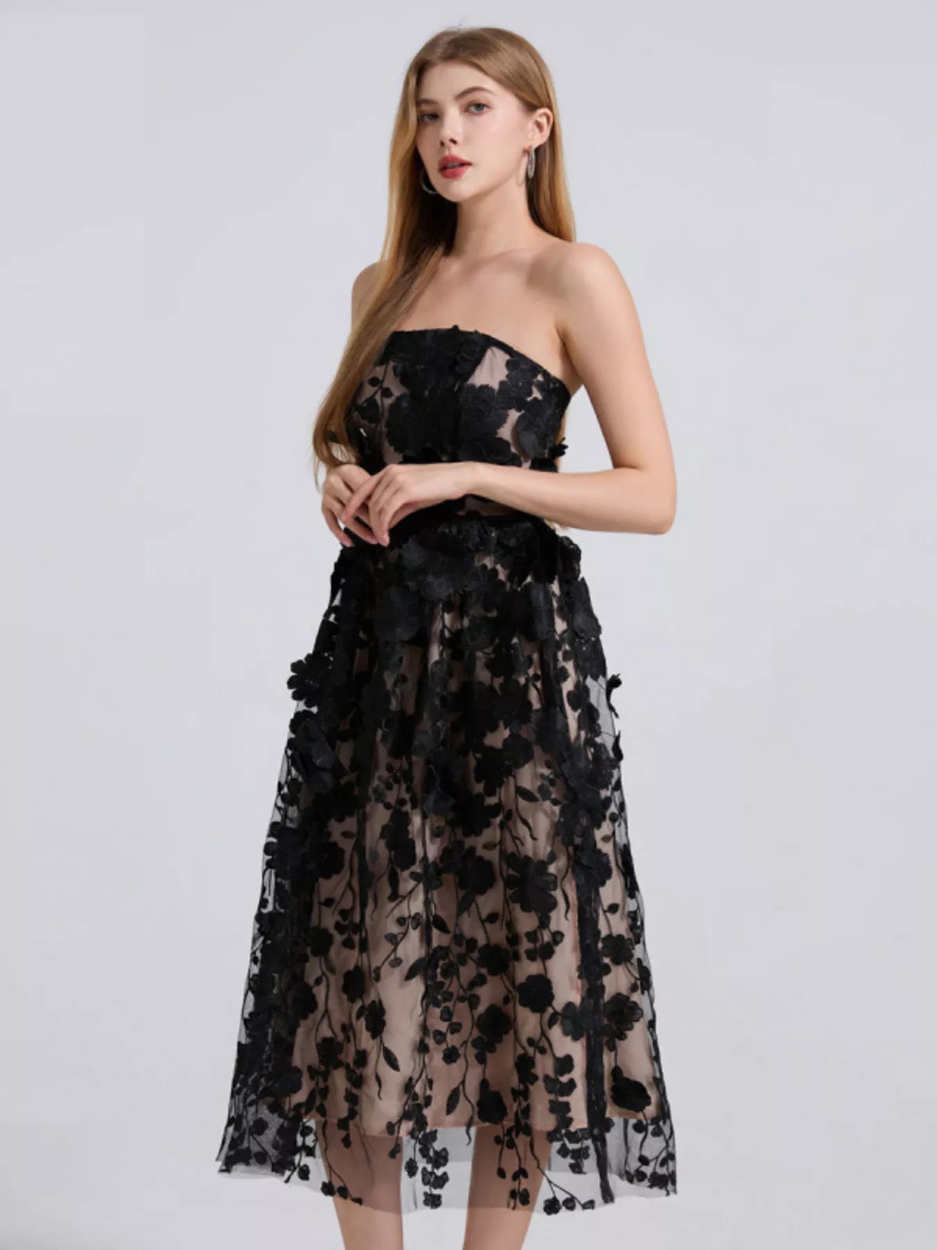 NEWYORKLISTED STYLE COLLECTION: Black lace strapless dress worn by a model on a white background