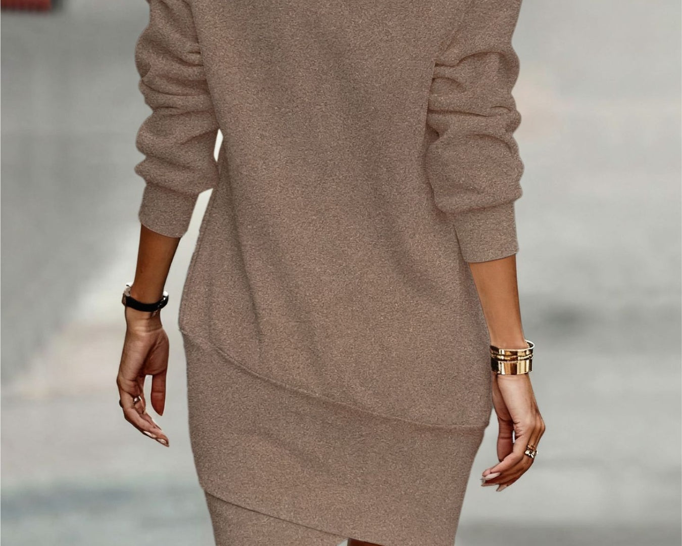 NEWYORKLISTED Style Collection: Person wearing a brown sweater dress with blurred background