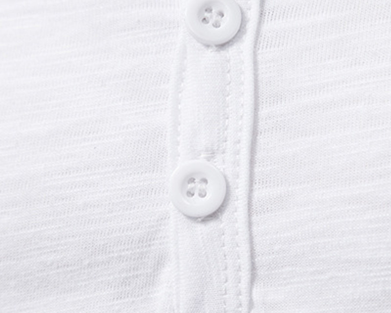 NEWYORKLISTED ATLAS MEN'S COLLECTION: Close-up of a white shirt with buttons on a white background