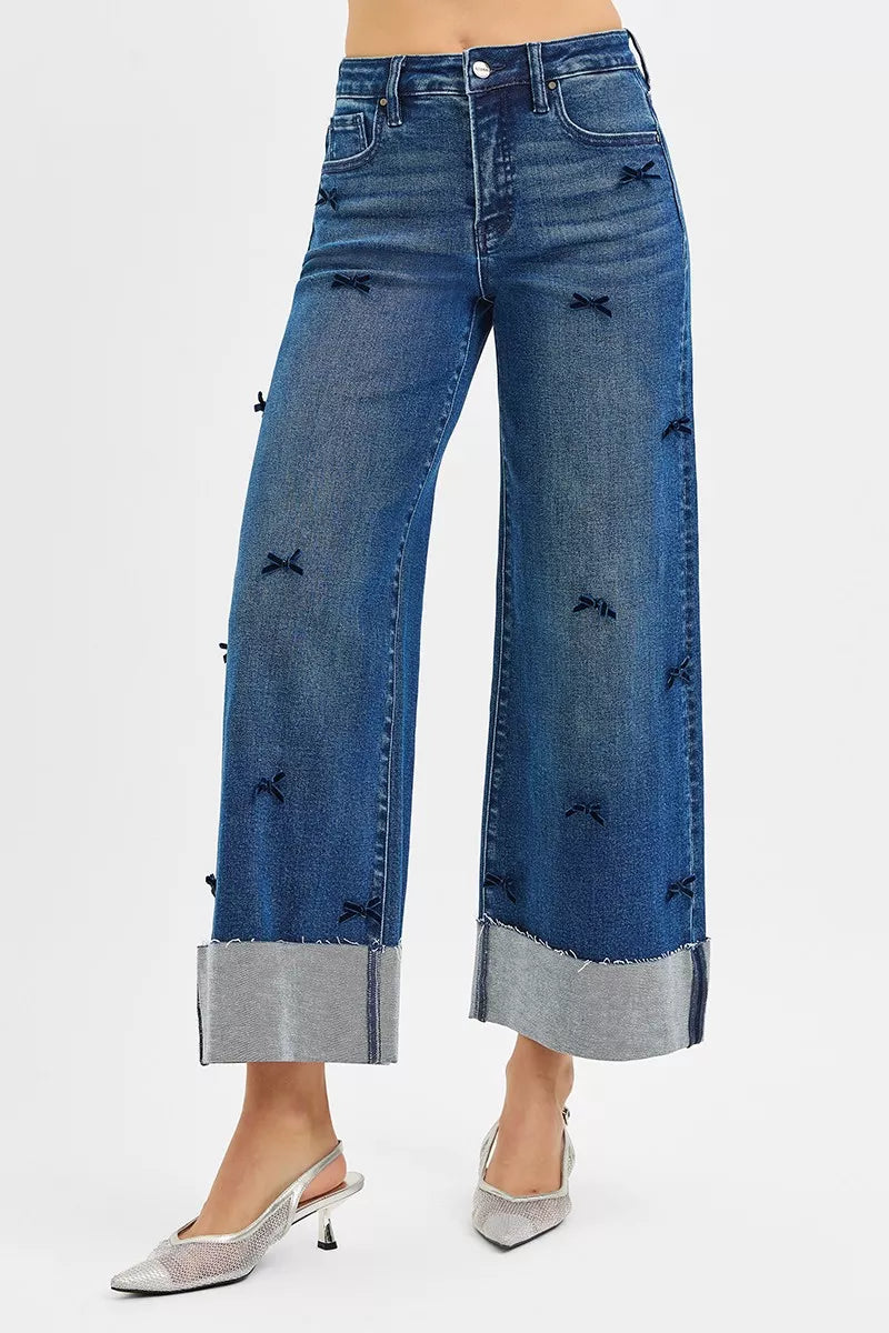 NEWYORKLISTED STYLE COLLECTION: Blue wide-leg jeans with decorative elements on a white background