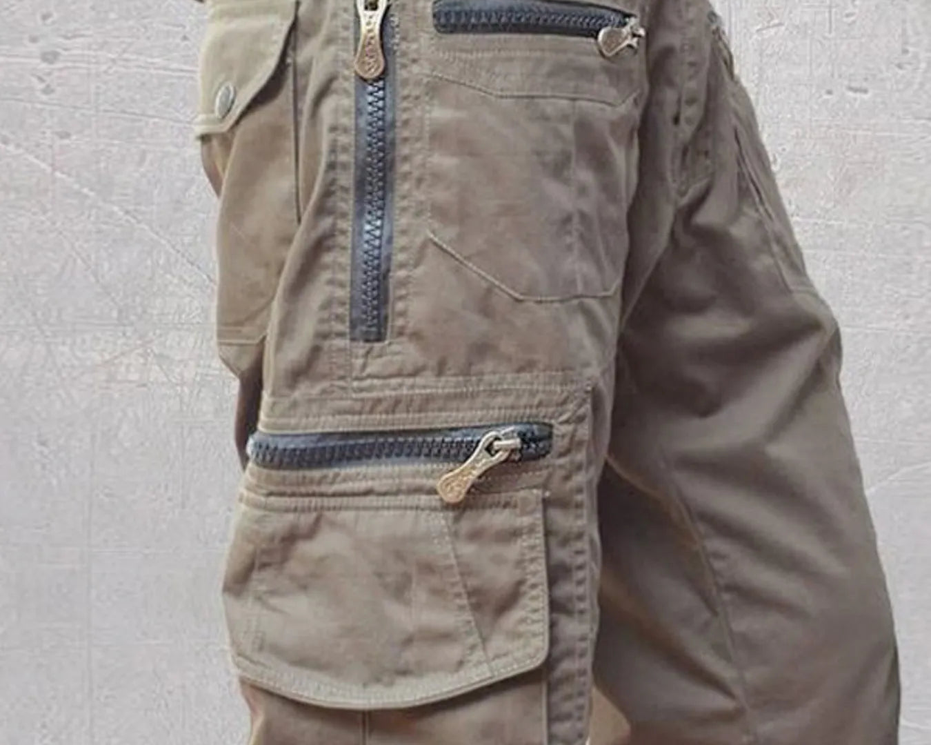 NEWYORKLISTED ATLAS MEN'S COLLECTION: Brown cargo shorts with multiple pockets and zippers on a light gray background