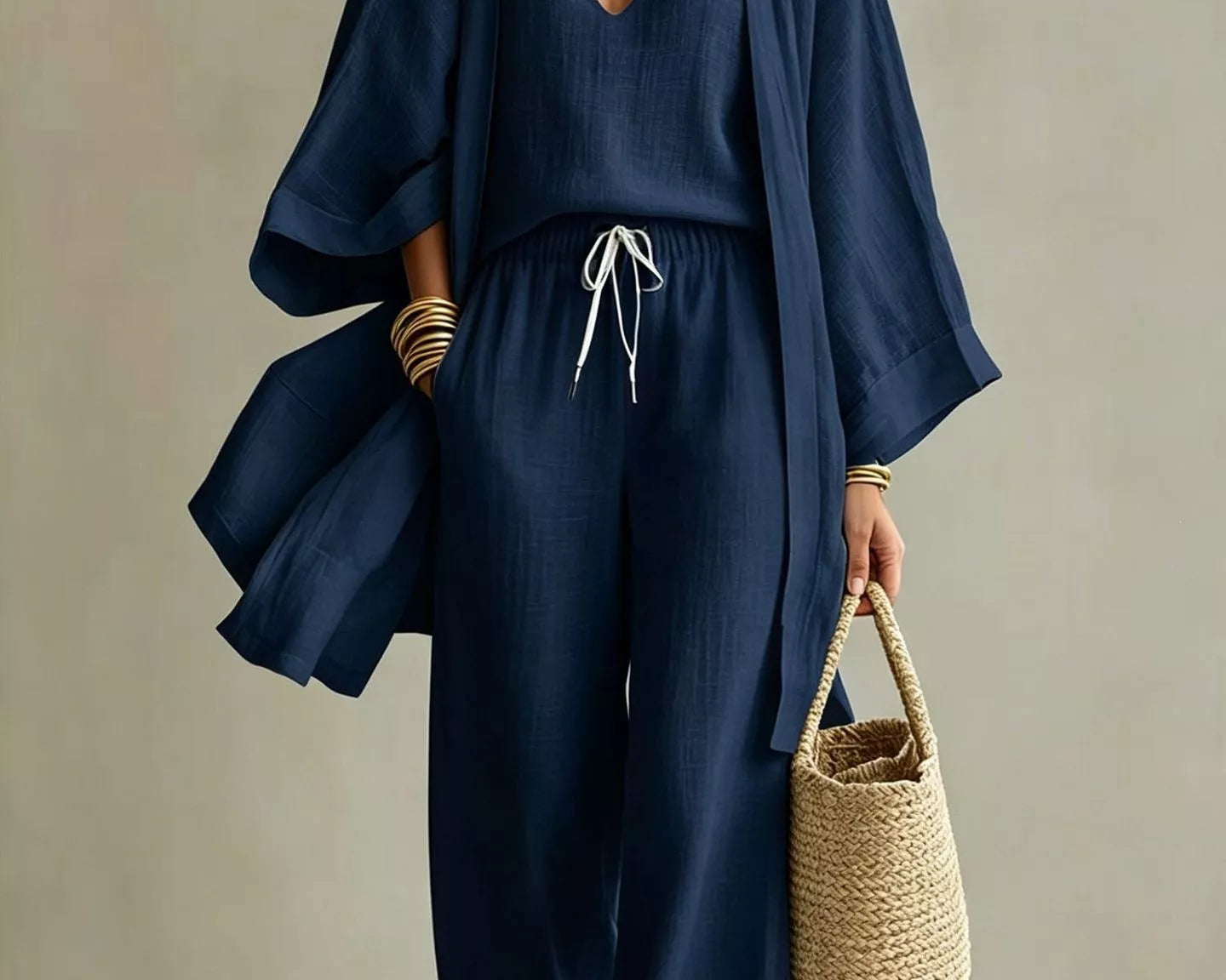 NEWYORKLISTED STYLE COLLECTION: Woman wearing a navy blue outfit with a beige background