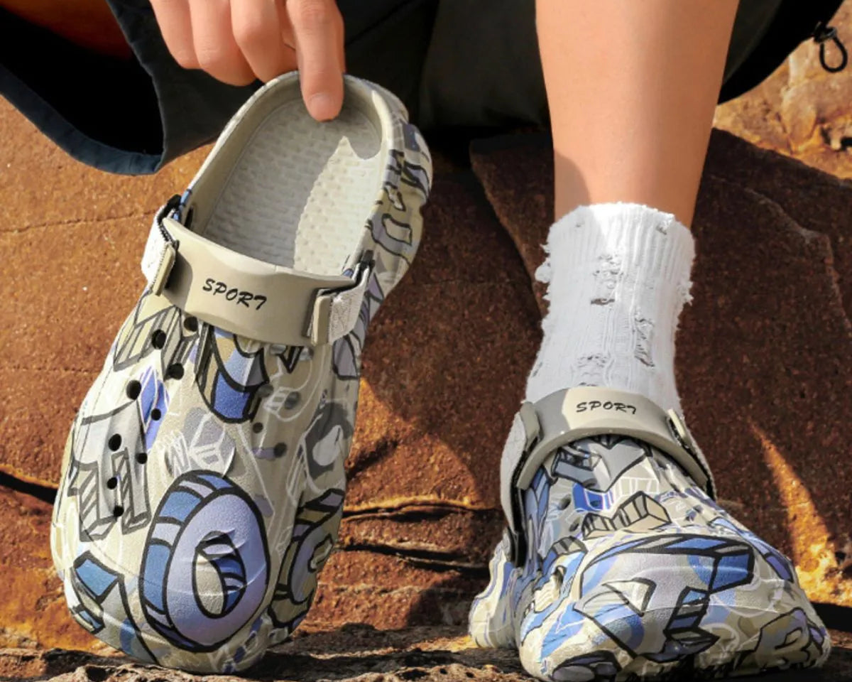 NEWYORKLISTED ATLAS MEN'S COLLECTION: Person wearing patterned clogs on a rocky surface